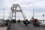 Sejumlah pekerja menyelesaikan pekerjaan akhir jembatan Bengawan Solo yang menghubungkan Kecamatan Kota-Trucuk, Bojonegoro, Jawa Timur, Senin (24/12). Jembatan Bengawan Solo  sepanjang 145 meter, lebar 9,75 meter memiliki model lengkung 