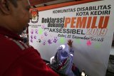 Warga difabel memberi cap tangan pada papan saat 'Deklarasi Dukung Pemilu yang Aksessibel' di Komisi Pemilihan Umum (KPU) Kota Kediri, Jawa Timur, Sabtu (15/12/2018). Kegiatan tersebut bertujuan meningkatkan partisipasi difabel pada Pemilu 2019. Antara Jatim/Prasetia Fauzani/ZK.