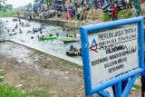 Warga bermain air di Irigasi Leuweung Seureuh, Desa Bangle, Karawang, Jawa Barat, Minggu (20/01/2019). Irigasi tersebut menjadi wahana alternatif  bermain air bagi masyarakat untuk mengisi waktu libur akhir pekan. ANTARA JABAR/M Ibnu Chaza/agr. 