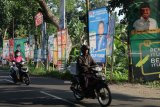 Pengendara sepeda motor melintas di depan sejumlah alat peraga kampanye (APK) yang terpasang di pinggir jalan di Kota Kediri, Jawa Timur, Senin (7/1/2019). Meskipun petugas Satuan Polisi Pamong Praja telah melakukan penertiban secara berkelanjutan, banyak APK yang menyalahi aturan pemasangan masih terus bermunculan di sejumlah titik. Antara Jatim/Prasetia Fauzani/ZK