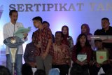 Presiden RI Joko Widodo berbincang dengan perwakilan warga penerima sertifikat tanah saat penyerahan sertifikat untuk rakyat di Pendopo Sasana Adhi Praja, Blitar, Jawa Timur, Rabu (3/1/2019). Penyerahan 2.500 sertifikat kepada warga didaerah itu merupakan bagian dari program pemerintah dalam hal penerbitan sertifikat bagi takyat yang pada tahun 2019 ini ditargetkan sebanyak 9 juta sertifikat lagi dirampungkan. Antara Jatim/Irfan Anshori/ZK.