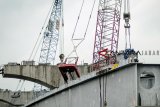 Pekerja memasang girder box pada proyek pembangunan jalan layang tol Cikampek di kilometer 36, Cikarang, Jawa Barat, Minggu (27/1/2019). Proyek jalan layang tol dengan panjang 36,4 kilometer yang sempat diberhentikan dan dilanjutkan kembali pada delapan Januari lalu itu saat ini telah mencapai 62 persen dan ditargekan rampung pada Juni 2019. ANTARA JABAR/Raisan Al Farisi/agr. 