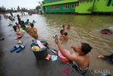 Sejumlah warga menggunakan air sungai untuk keperluan mandi dan mencuci pakaian di Sungai Baru,Banjarmasin,Kalimantan Selatan,  Minggu (17/2/2019).Dua hari terakhir kota Banjarmasin krisis air bersih akibat bocornya pipa air baku intake Sungai Tabuk ke Instalasi Pengolahan Air (IPA) yang berdiameter 1200 millimeter milik PDAM Bandarmasih. Foto Antaranews Kalsel/Bayu Pratama S