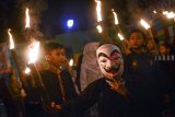 Sejumlah anak mengikuti pawai obor di Lio Genteng, Bandung, Jawa Barat, Sabtu (16/2/2019). Pawai obor yang diikuti puluhan anak beserta warga tersebut dilakukan dalam rangka memperingati hari lahir almarhumah Inggit Garnasih ke-131. ANTARA JABAR/Raisan Al Farisi/agr.