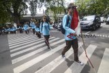 Siswa tunanetra dari SLBN A Kota Bandung menyeberangi jalan saat mengikuti orientasi dan mobilitas di Bandung, Jawa Barat, Senin (25/2/2019). Orientasi dan mobilitas siswa tunanetra yang bertemakan 