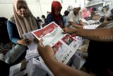 Pekerja melakukan pelipatan kertas suara pilpres di Gudang KPU, Cibinong, Bogor, Jawa Barat, Kamis (7/3/2019).  KPU Kabupaten Bogor mulai melakukan pelipatan kertas suara sebagai persiapan pilpres 2019 yang akan didistribusikan ke 40 kecamatan di Kabupaten Bogor. ANTARA FOTO/Yulius Satria Wijaya/agr.