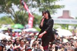 Penyanyi Isyana Sarasvati menyapa para peserta Millenial Road Safety Festival di komplek perkantoran Pemprov Kalsel, Banjarbaru, Kalimantan Selatan,  Minggu (17/3/2019).Millenial Road Safety Festival di Kalsel merupakan kampanye tertib dan selamat berlalu lintas kalangan Millenial usia 15-35 tahun, yang dimeriahkan dengan berbagai acara seperti Color Fun Walk dan mendatangkan penyanyi Isyana Sarasvati. Foto Antaranews Kalsel/Bayu Pratama S.