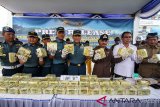 Dan Lantamal I Laksamana Pertama TNI Ali Triswanto (tengah), Bupati Aceh Utara Muhammad Thaib (kedua kanan), Kepala BNN Lhokseumawe AKBP Fakhrurrozi (kanan) menunjukkan barang bukti narkotika jenis Sabu di Mako Lanal Lhokseumawe, Aceh, Selasa (19/3/2019). Tim F1QR Lanal Lhokseumawe Lantamal I Koarmada berhasil menggagalkan upaya penyeludupan 50 kilogram Sabu asal Thailand di perairan Ujong Blang Aceh, dan menangkap empat sindikat narkotika internasional Thailand-Aceh berinisial IS (36), HS (26), IR (27) dan MA (26) berikut satu pucuk senjata api jenis FN bersama tujuh butir amunisi. (Antara Aceh/Rahmad)