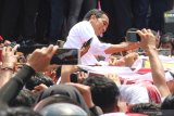 Capres nomor urut 01 Joko Widodo berfoto bersama pendukung saat menggelar kampanye terbuka di Jalan Arteri Supadio, Kabupaten Kubu Raya, Kalimantan Barat, Rabu (27/3/2019). Selain memaparkan sejumlah pembangunan infrastruktur yang telah dikerjakan seperti perbatasan, pelabuhan dan bandara di wilayah Kalbar, Jokowi juga menjanjikan akan membangun jalan tol dan jembatan di provinsi tersebut. ANTARA FOTO/Jessica Helena Wuysang