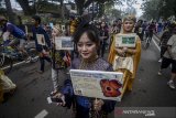 Sejumlah komunitas mahasiswa Kalimantan Timur menggunakan pakaian adat saat pawai budaya Kalimantan Timur di Hari Bebas Kendaraan Bermotor, Bandung, Jawa Barat, Minggu (7/4/2019). Pawai budaya yang diselenggarakan oleh komunitas mahasiswa-mahasiswi Kalimantan Timur tersebut ditujukan untuk memperkenalkan budaya Kalimantan Timur di Bandung. ANTARA JABAR/Raisan Al Farisi/agr