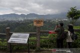 Warga berfoto di dekat rambu informasi dan mitigasi zona Sesar Lembang di Kawasan Tebing Keraton, Kabupaten Bandung, Jawa Barat, Kamis (25/4/2019). Badan Nasional Penanggulangan Bencana (BNPB) memasang rambu di zona Sesar Lembang di tiga titik yang tersebar di Kabupaten Bandung dan Bandung Barat guna  mengingatkan warga akan potensi bencana Sesar Lembang. ANTARA JABAR/Novrian Arbi/agr