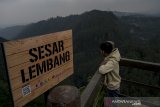 Warga menikmati keindahan alam di dekat rambu informasi dan mitigasi zona Sesar Lembang di Kawasan Tebing Keraton, Kabupaten Bandung, Jawa Barat, Kamis (25/4/2019). Badan Nasional Penanggulangan Bencana (BNPB) memasang rambu di zona Sesar Lembang di tiga titik yang tersebar di Kabupaten Bandung dan Bandung Barat guna  mengingatkan warga akan potensi bencana Sesar Lembang. ANTARA JABAR/Novrian Arbi/agr