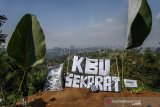 Warga bersama aktivis dari Wahana Lingkungan Hidup (Walhi) Jabar membentangkan spanduk bertuliskan 'KBU (Kawasan Bandung Utara) Sekarat' saat melakukan aksi protes di Desa Pagerwangi, Kabupaten Bandung Barat, Jawa Barat, Kamis (25/4/2019). Aksi tersebut  merupakan bentuk protes, keresahan dan keprihatinan terhadap kondisi Kawasan Bandung Utara dengan semakin  masifnya alih fungsi lahan serta hutan di Kawasan Bandung Utara (KBU) yang berpotensi menjadi penyebab bencana di sekitar Bandung Raya. ANTARA JABAR/Novrian Arbi/agr