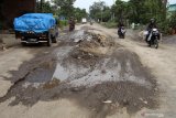 Kendaraan melintas di jalan raya yang berlubang dan bergelombang di ruas Desa Bulang,  Prambon, Sidoarjo, Jawa Timur, Jumat (26/4/2019). Jalur alternatif perbatasan antara Sidoarjo-Mojokerto tersebut rusak parah sepanjang 1 Km dengan kedalaman 20-30 cm disebabkan banyaknya kendaraan truk besar yang melintas dan saluran drainase kurang efektif saat musim hujan. Antara Jatim/Umarul Faruq/zk.
