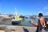 Nelayan menyaksikan deretan perahu yang ditambatkan di Pelabuhan Branta Pesisir, Pamekasan, Jawa Timur, Senin (6/5/2019). Awal bulan Ramadhan 1440 H. nelayan di Madura tidak melaut guna fokus beribadah puasa sekaligus proses adaptasi selama dua hari. Antara Jatim/Saiful Bahri/zk.