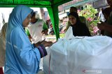 Petugas melayani pembeli di Warung Nabung Berkah Tebuireng, Jombang, Jawa Timur, Kamis (9/5/2019). Setiap hari selama bulan puasa Ramadhan Lembaga Sosial Pesantren Tebuireng (LSPT) melalui Warung Nabung Berkah menyediakan 150-200 kotak nasi yang dijual Rp2 ribu untuk orang-orang yang kurang beruntung secara ekonomi. Antara Jatim/Syaiful Arif/zk.