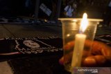 Warga menyalakan lilin di dekat syal bergambar Marsinah, Wiji Thukul dan Munir pada aksi mengenang 26 tahun kasus Marsinah di Taman Vanda, Bandung, Jawa Barat, Kamis (9/5/2019). Aksi tersebut merupakan peringatan untuk 26 tahun kasus pembunuhan Marsinah yang belum tuntas hingga saat ini. ANTARA JABAR/Novrian Arbi/agr