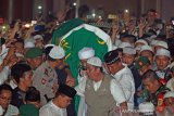 Ratusan muslim mengusung peti jenazah KH. Arifin Ilham saat akan dimakamkan di Komplek Pesantren Az Zikra Gunung Sindur, Bogor, Jawa Barat, Kamis (23/5/2019) malam. Arifin Ilham meninggal karena sakit kanker getah bening yang dideritanya. ANTARA FOTO