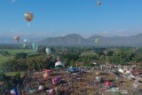 Warga menerbangkan balon udara saat mengikuti Festival Balon Ponorogo 2019 di Desa Nongkodono, Ponorogo, Jawa Timur, Rabu (12/6/2019). Festival balon yang digelar Kementerian Perhubungan bekerja sama dengan AirNav Indonesia, kepolisian dan pemerintah daerah setempat tersebut dilakukan untuk mensosialisasikan dan melestarikan tradisi balon udara yang aman dengan cara ditambatkan menggunakan tali untuk meminimalisir penerbangan balon udara secara liar yang dapat membahayakan keselamatan penerbangan. Antara Jatim/Fikri Yusuf/ZK