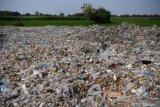 Tumpukan sampah plastik impor yang berada di sekitar pemukiman warga di Desa Bangun di Mojokerto, Jawa Timur, Rabu (20/6/2019). Berdasarkan data Lembaga Kajian Ekologi dan Konservasi Lahan Basah Ecoton bahwa masuknya sampah dengan merk dan lokasi jual di luar Indonesia, diduga akibat kebijakan Cina menghentikan impor sampah plastik dari sejumlah negara di Uni Eropa dan Amerika yang mengakibatkan sampah plastik beralih tujuan ke negara-negara di ASEAN. Indonesia diperkirakan menerima sedikitnya 300 kontainer yang sebagian besar mengangkut sampah plastik ke Jawa Timur setiap harinya.  Antara Jatim/Zabur Karuru