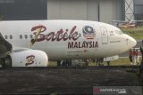 Petugas melakukan pemeriksaan pesawat Maskapai Malindo Air (Batik Malaysia) yang keluar dari landas pacu di Bandar Udara Internasional Husein Sastranegara, Bandung, Jawa Barat, Kamis (20/6/2019). Sebanyak 114 penumpang dan delapan kru pesawat berhasil dievakuasi dengan selamat dan aman setelah maskapai penerbangan bernomor OD-301 yang beroperasi dengan Boeing 737-800NG tujuan Bandung-Malaysia tersebut tergelincir keluar landas pacu Bandar Udara Internasional Husein Sastranegara saat berbelok sebelum lepas landas. ANTARA JABAR/Novrian Arbi/agr