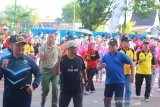 Gubernur Kalsel Sahbirin Noor (ketiga kiri) bersama Kapolda Kalsel Irjen Pol Yazid Fanani  dan Forkopimda Kalsel melakukan senam saat olahraga bersama TNI, POLRI, PEMDA, dan Masyarakat di jalan Jendral Sudirman, Banjarmasin, Kalimantan Selatan, Jumat (21/6/2019).Dalam Rangka Hari Bhayangkara ke-73 Tahun 2019 Polda Kalsel mengadakan olahraga bersama dan deklarasi Indonesia damai anti kerusuhan bersama TNI, POLRI, Prmda, dan Masyrakat.Foto Antaranews Kalsel/Bayu Pratama S.