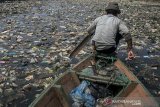 Warga menggunakan perahu untuk memilah sampah plastik di aliran Sungai Citarum, Batujajar, Kabupaten Bandung Barat, Jawa Barat, Rabu (26/6/2019). Menurut warga di kawasan tersebut volume sampah kiriman yang kerap menumpuk mulai mengalami penurunan setelah beberapa waktu lalu sempat menutupi permukaan aliran Sungai Citarum. ANTARA JABAR/Novrian Arbi/agr