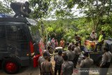 Warga dibantu anggota Polisi dan TNI mengisi air bersih gratis yang didistribusikan dari Polres Tasikmalaya Kota menggunakan mobil water cannon berisi 6.000 liter air di Desa Cijualang, Kabupaten Tasikmalaya, Jawa Barat, Kamis (27/6/2019). Sejak dua bulan lalu, daerah tersebut mengalami krisis air bersih karena dampak dari terjadinya kekeringan akibat dilanda musim kemarau, sehingga warga harus mengambil air bersih dengan jarak tempuh dua kilometer. ANTARA JABAR/Adeng Bustomi/agr