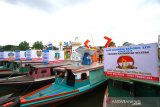 Sejumlah pekerja menyelesaikan hiasan di perahu bermesin (kelotok) di Sungai Martapura Banjarmasin, Kalimantan Selatan, Selasa (2/7/2019).Sebanyak 34 perahu bermesin (kelotok) disiapkan untuk memeriahkan parade jukung hias dalam rangka Hari Keluarga Nasional (HARGANAS) ke-26 tahun 2019.Foto Antaranews Kalsel/Bayu Pratama S.
