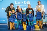 Direktur Kepatuhan bank bjb Agus Mulyana (kanan) bersama Direktur Keuangan dan Manajemen Risiko Nia Kania (kedua kanan) Direktur Konsumer dan Ritel Suartini (kedua kiri) dan Direktur Operasional Tedi Setiawan (kiri) memberikan bingkisan kepada perwakilan anak-anak saat program CSR bank bjb khitanan massal di Bandung, Jawa Barat, Rabu (3/7/2019). Khitanan massal yang diikuti oleh 200 peserta ini merupakan program yang diselenggarakan bank bjb sebagai bentuk tanggung jawab sosial perusahaan khususnya terhadap masyarakat sekitar dalam rangka menyambut Hari Anak Nasional yang jatuh pada tanggal 23 Juli 2019. ANTARA JABAR/M Agung Rajasa/agr