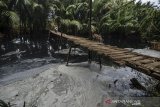 Warga melintas di jembatan sungai Citonjong yang tercemar limbah pabrik di Dusun Ciokong, Desa Sukaresik, Kabupaten Pangandaran, Jawa Barat, Jumat (19/7/2019). Sebanyak dua desa kecamatan Sindamulih terdampak pencemaran sungai yang diduga berasal dari limbah pabrik sehingga mengakibatkan air keruh, bau menyengat serta merusak ekosistem sungai. ANTARA JABAR/Adeng Bustomi/agr