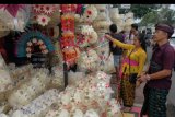 Calon pembeli memilih pernak-pernik perlengkapan sesajen berbahan daun lontar menjelang Hari Raya Galungan di Desa Kapal, Badung, Bali, Sabtu (20/7/2019). Umat Hindu di Bali akan merayakan Hari Galungan pada Rabu (24/7) yaitu perayaan hari kemenangan 