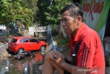 Warga melihat mobil Honda Brio masuk sungai setelah menabrak dua motor yang parkir di tepi Jalan Adityawarman Jombang, Jawa Timur, Senin (22/7/2019). Kecelakaan tersebut diduga disebabkan pengemudi belum mahir mengendarai mobil matic barunya, karena saat belok terlalu mengambil haluan ke kanan sehingga menabrak 2 motor yang sedang parkir. Tidak ada korban jiwa dalam peristiwa itu. Antara Jatim/Syaiful Arif/zk