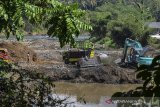 Pekerja memasukkan pasir ke bak truk dengan alat berat di aliran Sungai Ciwulan, Jatiwaras, Kabupaten Tasikmalaya, Jawa Barat, Kamis (25/7/2019). Penambangan pasir yang diduga tidak berizin tersebut dapat menyebabkan terjadinya longsor dan penyurutan air sungai dan mengganggu ekosistem di aliran sungai. ANTARA JABAR/Adeng Bustomi/agr.
