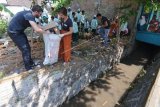 Relawan asing membersihkan sampah