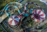 Foto udara kondisi kolam renang Banjar Water Park (BWP) yang memperihatinkan dan tidak terawat, di Kota Banjar, Jawa Barat, Jumat (9/8/2019). Destinasi wisata BWP milik pemerintah daerah Kota Banjar yang dikelola oleh  Badan Usaha Milik Daerah (BUMD) yang dibangun pada tahun 2009 menghabiskan anggaran APBD senilai Rp27 miliar terbengkalai dan beberapa fasilitas rusak parah akibat terus merugi dan membenani APBD, sehingga tidak beroperasi sejak tiga tahun yang lalu. ANTARA JABAR/Adeng Bustomi/agr