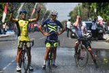 Sejumlah pebalap sepeda membahasi dirinya dengan air seusai finish etape pertama Tour de Indonesia 2019 di alun-alun Kabupaten Ngawi, Jawa Timur, Senin (19/8/2019). Etape pertama dimulai dari Candi Borobudur, Jawa Tengah dan berakhir di alun-alun Kabupaten Ngawi Jawa Timur dengan jarak tempuh 186,6 Km. ANTARA FOTO/Sigid Kurniawan/nym.