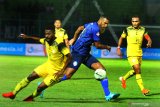 Pesepakbola Arema FC, Sylvano Comvalius (tengah)  berusaha melewati hadangan pesepakbola Barito Putra, Donny Harold Monim (kiri) dalam pertandingan Liga I di Stadion Kanjuruhan, Malang, Jawa Timur, Senin (19/8/2019). Arema mengalahkan Barito Putra dengan skor akhir 2-1. Antara Jatim/Ari Bowo Sucipto/zk