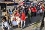 Warga mengarak dongdang keliling kampung saat tradisi hajat bumi di Desa Cemarajaya, Karawang, Jawa Barat, Selasa (3/9/2019). Tradisi tersebut dilakukan dalam tiga tahun sekali dalam kepercayaan warga pesisir laut utara untuk menolak bala dan sebagai rasa bersyukur atas rezeki melalui hasil bumi yang diberikan Tuhan. ANTARA FOTO/M Ibnu Chazar/agr