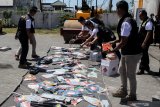 Petugas dari Perlindungan Konsumen dan Tertib Niaga (PKTN) kemendag memusnahkan barang hasil temuan impor tidak sesuai izin di kawasan Pergudangan Tambak Langon Surabaya, Jawa Timur, Selasa (10/9/2019). Kementerian Perdagangan melalui Direktorat Jenderal Perlindungan Konsumen dan Tertib Niaga (PKTN) memusnahan barang hasil temuan impor tidak sesuai izin berupa raket nyamuk, korek api, minyak ikan, luminer, dan kertas kanvas senilai Rp8 miliar dari empat importir. Antara Jatim/Umarul Faruq/zk