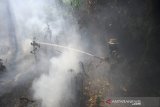 Personel TNI berupaya memadamkan Kebakaran hutan dan lahan (Karhutla) di kawasan Guntung Damar, Banjarbaru, Kalimantan Selatan, Rabu (25/9/2019). Petugas gabungan terus berupaya memadamkan kebakaran hutan dan lahan di kawasan dekat dengan Bandara dan rumah penduduk sementara Polda Kalsel telah menetapkan 20 tersangka pembakar lahan, dua diantaranya dari korporasi. Foto Antaranews Kalsel/Bayu Pratama S.