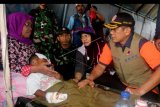 Kepala Badan Nasional Penanggulangan Bencana (BNPB) Doni Monardo (kanan) mengunjungi pasien korban gempa yang dirawat di rumah sakit lapangan yang dibangun TNI di kompleks Kampus Universitas Darussalam, Desa Tulehu, Pulau Ambon, Kabupaten Maluku Tengah, Maluku, Jumat (27/9/2019). Para pasien tersebut merupakan korban gempa bumi berkekuatan magnitudo 6,8 yang mengguncang Pulau Ambon dan sekitarnya Kamis (26/9/2019). ANTARA FOTO/Izaac Mulyawan/nym