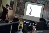 Pewarta foto LKBN Antara Zabur Karuru (kiri) menyampaikan materi foto jurnalistik kepada mahasiswa dari UKM Fotografi Himmarfi STIKOSA-AWS di Kantor LKBN Antara Biro Jawa Timur di Surabaya, Jawa Timur, Kamis (3/10/2019). Materi kelas fotojurnalistik yang diikuti 11 mahasiswa ini diantaranya mengenai dasar-dasar foto jurnalistik dan kiat-kiat dalam membuat foto cerita. Antara Jatim/Naufal Ammar/zk.