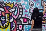 Seniman menyelesaikan karya seni graffiti dalam acara Ladies on Wall 2019 di Karawang, Jawa Barat, Minggu (13/10/2019). Acara tersebut diselenggarakan oleh Kementerian Pendidikan dan Kebudayaan bekerjasama dengan Ledies on Wall untuk mengapresiasi seniman graffiti perempuan di Indonesia. ANTARA FOTO/M Ibnu Chazar/agr