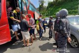 Sejumlah Pekerja Migran Indonesia (PMI) berbaris untuk menjalani pendataan saat tiba di Pos Lintas Batas Negara (PLBN) Entikong, Kabupaten Sanggau, Kalimantan Barat, Rabu (16/10/2019). KJRI Kuching Sarawak mengawal 53 PMI bermasalah yang dideportasi Malaysia melalui Depot Imigresen Bekenu Miri karena telah melanggar Undang-Undang Imigrasi setempat yaitu bekerja tanpa ijin. Sebelum dipulangkan ke Indonesia, mereka harus menjalani tahanan selama tiga bulan. ANTARA FOTO/Agus Alfian/jhw