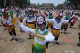 Penari memainkan tari 'Topeng Gethak' kolosal di Taman Mandhapa Aghung  Ronggosukowati, Pamekasan, Jawa Timur, Minggu (27/10/2019). Tari yang menggambarkan perjuangan kemerdekaan yang diikuti 489 penari itu, dalam rangka memeriahkan hari jadi ke 489 Pamekasan dan diharapkan mampu meningkatkan kunjungan wisatawan ke daerah tersebut. Antara Jatim/Saiful Bahri/zk.