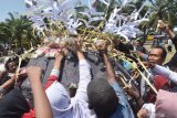 Warga berebut jajanan tradisional yang dirangkai dalam bentuk gunungan di Alun-alun Kota Madiun, Jawa Timur, Sabtu (9/11/2019). Gunungan yang terbuat dari rangkaian jajanan tradisional dan hasil bumi yang diperebutkan warga tersebut merupakan rangkaian kegiatan Grebeg Maulid yang digelar Pemkot Madiun untuk memperingati Maulid Nabi Muhammad SAW. Antara Jatim/Siswowidodo/zk.