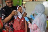 Petugas medis melakukan imunisasi difteri pada siswa di Sekolah Dasar Tanjungrejo 2, Malang, Jawa Timur, Rabu (14/11/2019). Imunisasi tersebut dilakukan di sejumlah sekolah untuk mengantisipasi penyebaran difteri pasca ditemukannya ratusan pelajar dan guru yang positif carrier atau pembawa bakteri difteri beberapa waktu lalu. Antara Jatim/Ari Bowo Sucipto/zk