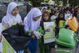 Sejumlah pelajar sekolah dasar melakukan aksi kampanye sadar lingkungan dan memungut sampah di kawasan Hari Bebas Kendaraan, Dago, Bandung, Jawa Barat, Minggu (17/11/2019). Aksi yang dilakukan dari sejumlah sekolah dasar di Kota Bandung tersebut guna sebagai edukasi secara nyata dalam menjaga kebersihan dan peduli lingkungan bagi anak usia dini. ANTARA JABAR/Novrian Arbi/agr