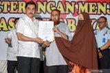 Kepala Badan Nasional Penanggulangan Terorisme (BNPT), Komjen Pol Suhardi (kiri) menyerahkan surat keputusan kepada narapidana terorisme Umar Patek (tengah) dan istrinya Gina Gutierez atau Ruqayyah binti Husein Luceno (kanan) di Lapas Kelas 1 Surabaya di Porong, Sidoarjo, Jawa Timur, Rabu (20/11/2019). Pemerintah melalui Menteri Hukum dan Hak Asasi Manusia Republik Indonesia menerbitkan surat bernomor M.HH-16.AH.10.01 THN 2019 tentang Kewarganegaraan Repulik Indonesia atas nama Gina Gutierez Luceno resmi menjadi warga Negara Indonesia (WNI) yang sebelumnya berkewarganegaraan Filipina. Antara Jatim/Umarul Faruq/zk